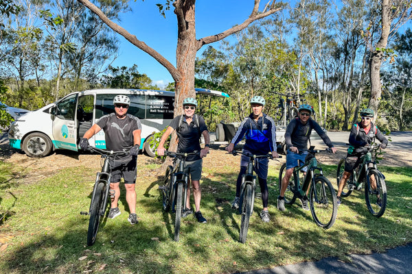 E Bike hire on the Northern Rivers Rail Trail and Ebike tours including the rail trail group of 5 men on FOCUS bikes preparing to set off on ebike tour