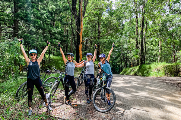 E Bike hire on the Northern Rivers Rail Trail and Ebike tours including the rail trail group of girls with FOCUS ebikes on trail in Mount Jerusalem National park on way to Unicorn Falls